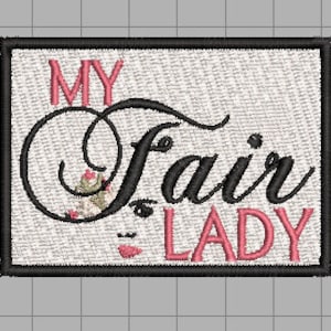 May include: A white embroidered patch with black and pink lettering that reads "My Fair Lady". The lettering is in a cursive font with floral accents.