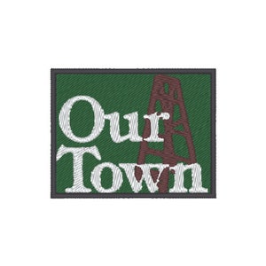 May include: Green embroidered patch with the text "Our Town" in white and a brown oil derrick in the background.