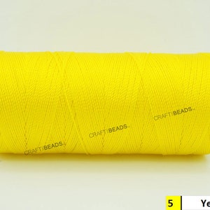 May include: A spool of bright yellow thread, labeled "CRAFT BEADS" and "5 Yellow".