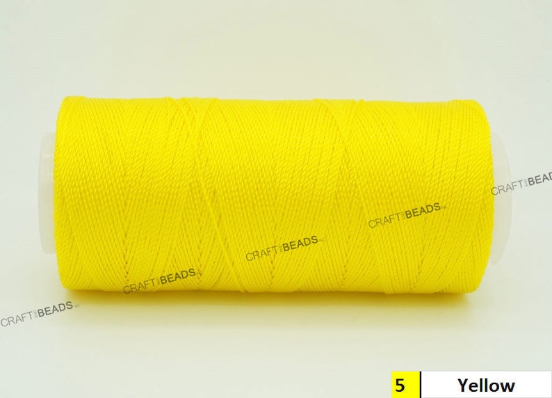 May include: A spool of bright yellow thread, labeled "CRAFT BEADS" and "5 Yellow".