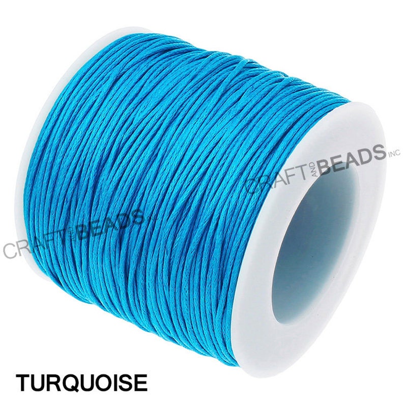 May include: A spool of turquoise waxed cotton cord. The cord is wound around a white plastic spool.