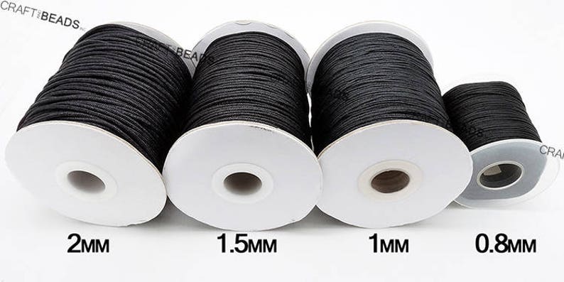 May include: Four spools of black waxed cotton cord, each with a different thickness: 2 mm, 1.5 mm, 1 mm, and 0.8 mm.