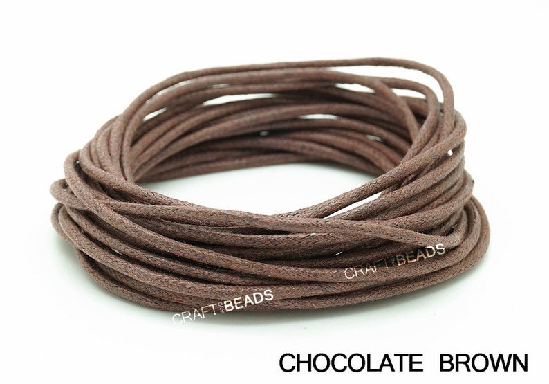 May include: A spool of brown waxed cotton cord. The cord is approximately 1 mm thick and is ideal for jewelry making, crafts, and other projects.