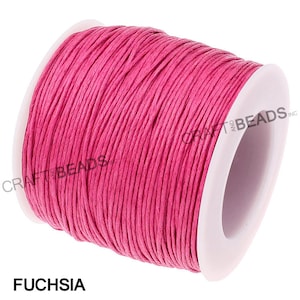 May include: A spool of fuchsia colored waxed cotton cord. The cord is wound around a white plastic spool with the text "CRAFT AND BEADS INC." printed on the side.