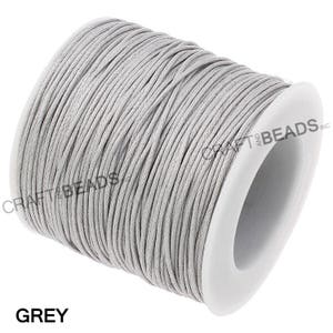 May include: A spool of grey waxed cotton cord, perfect for jewelry making, macrame, and other crafts.