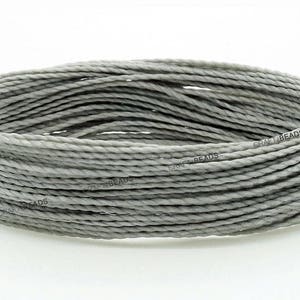 K&ouml;nnte beinhalten: Nahaufnahme einer Spule mit grauem, gedrehtem Kordel. Die Kordel besteht aus Naturfasern und ist perfekt f&uuml;r Bastelarbeiten.