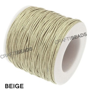 May include: A spool of beige waxed cotton cord, perfect for jewelry making, macrame, and other crafts.