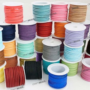 May include: Assortment of 20 spools of suede cord in various colours, including blue, green, brown, orange, red, and purple. The spools are arranged in a circular pattern on a white surface. The text "CRAFT BEADS" is visible on several of the spools.