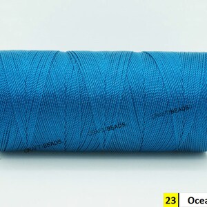 May include: A spool of bright blue thread, labeled "23 Ocean Blue".