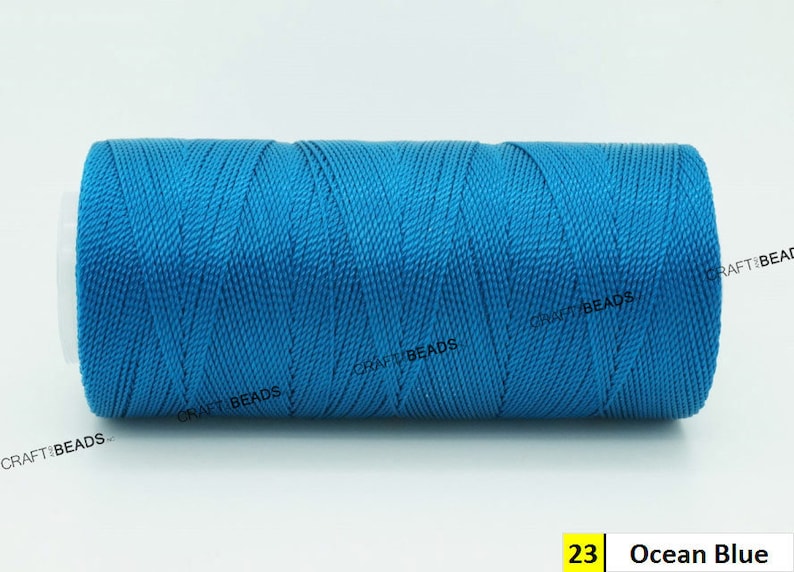 May include: A spool of bright blue thread, labeled "23 Ocean Blue".