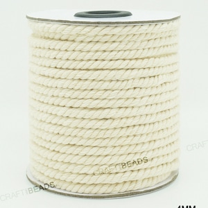 Pu&ograve; includere: Un rotolo di corda di cotone di colore naturale, di 4 mm di spessore, con la scritta "CRAFT BEADS INC" stampata sul lato.