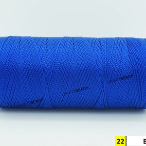 May include: A spool of blue thread, labeled "22 Blue" on a white background.