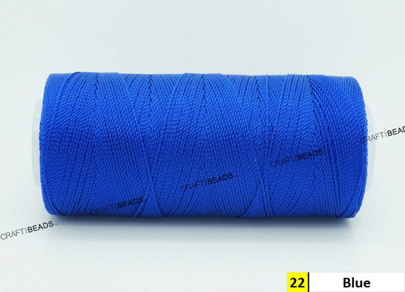 May include: A spool of blue thread, labeled "22 Blue" on a white background.