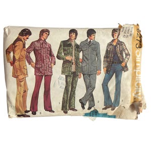 May include: A vintage Simplicity sewing pattern envelope, number 5273, featuring illustrations of five different jacket and trouser outfits. The paper envelope shows wear and includes text indicating size 46, chest 46, and waist 42.