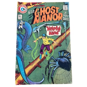 May include: Vintage comic book cover for "Ghost Manor" featuring a colorful illustration. The cover displays a scene with a man on a log, a large spider, and a blue snake. Text includes "Visit Ghost Manor" and "Helpful Hand".