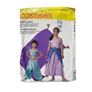 May include: A vintage McCall's Costumes pattern envelope featuring illustrations of children's princess and genie costumes. The envelope is yellowed with age and includes text in English and French, with sizes for girls.