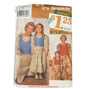 May include: A Simplicity sewing pattern package featuring a mother and daughter in matching floral dresses with blue vests. The package includes the text "It's Simplicity new!" and the price $1.25 U.S.A.