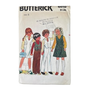 May include: Vintage Butterick sewing pattern envelope featuring illustrations of children in school attire. The envelope includes the text "Butterick", "Size 3", and "No Refunds or Exchanges on Patterns Mill Fabrics". The illustration shows four children in school uniforms.
