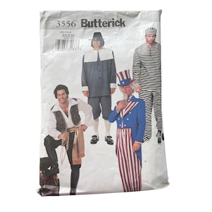 May include: A vintage Butterick sewing pattern packet featuring illustrations of four different costume designs. The costumes include a pilgrim, a pirate, Uncle Sam, and a prisoner. The packet is labeled "3556" and includes size information.