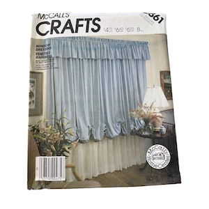 May include: A McCall's Crafts pattern envelope featuring a window dressing design. The image shows a light blue curtain with a ruffled valance and a white lower section. The envelope has text that reads "Window Dressing" and "Crafts".