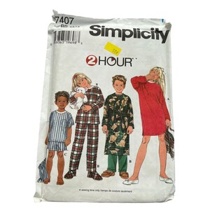 May include: A Simplicity 7407 sewing pattern envelope featuring illustrations of children wearing pajamas, a robe, and a nightgown. The package includes the text 2 HOUR and a yellow price sticker. The pattern is for sizes 5, 6, 7, and 8.