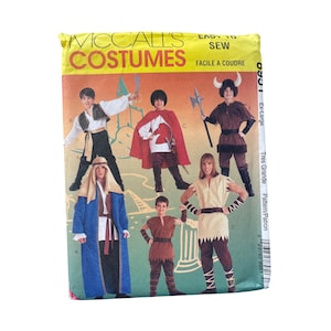 May include: A McCall's Costumes sewing pattern package featuring various costume designs. The package displays images of children and adults in medieval and fantasy-themed outfits, including capes, tunics, and armor.