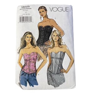 May include: Vogue V8325 sewing pattern envelope for size F (16-18-20) featuring illustrations of three strapless corset-style tops. One top is black, one is pink with a gold chain print, and one is grey with side panels, shown with jeans or skirts.