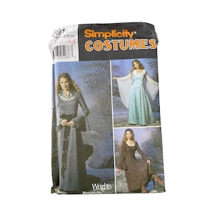 May include: Simplicity Costumes pattern featuring medieval-style dresses. The pattern packet shows three different dress designs in shades of gray, blue, and brown. The packet has the Simplicity Costumes logo and the Wrights Simplicity Trims logo.