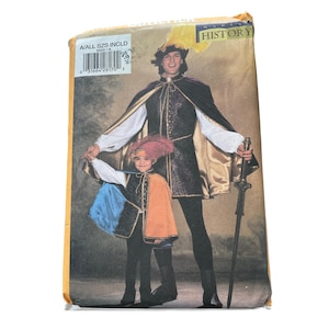May include: A costume pattern package featuring two people in Renaissance-style outfits. The adult wears a black and gold cape, tunic, and hat with a feather. The child wears a cape with blue and orange panels and a matching hat.