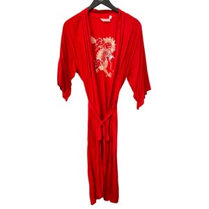 May include: A vibrant red robe with a matching belt, hanging on a black hanger. The robe features a gold embroidered dragon design on the front. The robe has wide sleeves and a tie closure at the waist.