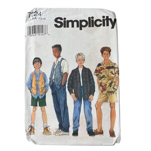 May include: Simplicity sewing pattern featuring illustrations of four boys in various outfits. The pattern includes the number 7224 and a barcode. The boys are wearing shirts, vests, shorts, and pants.