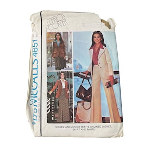 May include: Vintage McCall's 4651 sewing pattern for misses' and junior petite unlined jacket, skirt, and pants. The pattern features images of women wearing the garments. The pattern is in a white and off-white envelope.