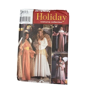 May include: Simplicity Holiday costume collection pattern. The pattern features images of angel costumes in various styles. The cover is red and white with the word "Holiday" in large letters. The pattern includes sizes XS, S, M, L, and XL.