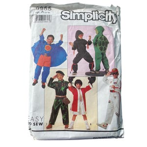 May include: Simplicity sewing pattern packet featuring children's costume designs. The costumes include a superhero, ninja, turtle, soldier, boxer, and race car driver. The packet is white with the number 9955 and the size A (3-8) printed on it.