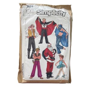 May include: A vintage Simplicity pattern envelope featuring illustrations of various costumes, including a pirate, a magician with a red cape, Santa Claus, and a ballerina. The envelope is tan with the number 7651 and size 2-4 printed on it.