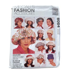 May include: McCall's Fashion Accessories 8084 sewing pattern envelope featuring illustrations of various hat styles including floral, solid, and textured designs. The text includes pattern number 8084 and head sizes 21-23 inches.