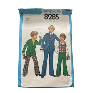 May include: Vintage Simplicity sewing pattern 8285 for boys' clothing. The pattern features illustrations of three boys in different outfits, including a suit, vest, and jacket. The pattern envelope is blue with the text "Simplicity" and "8285".