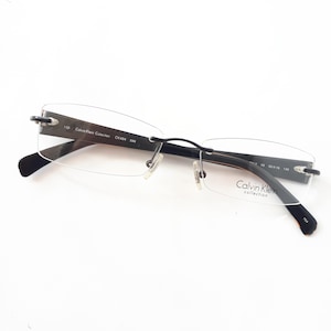 Calvin Klein Collection 484 599 eyeglasses  black brown rectangle metal women glasses frame small size plastic temples rimless used Brille