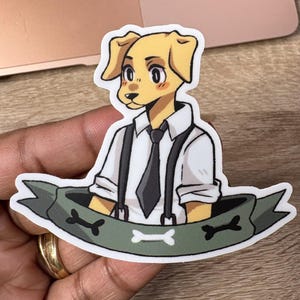 May include: A sticker featuring a cartoon dog character with yellow fur, wearing a white shirt, black tie, and suspenders. The dog is set against a green banner with bone graphics.