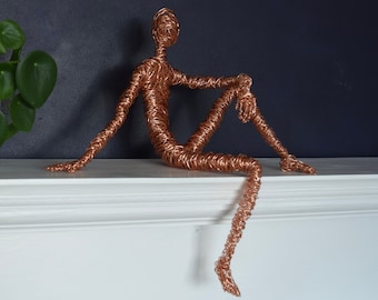 Copper seated figure