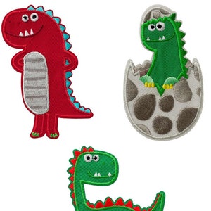 May include: Three embroidered iron-on patches featuring cartoon dinosaurs. One red dinosaur, one green dinosaur in an egg, and one green dinosaur.