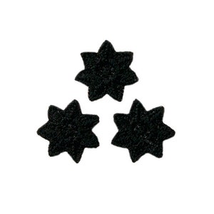 May include: Three black star-shaped embellishments.