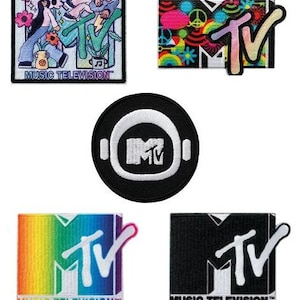 May include: Five different embroidered patches featuring the MTV logo. The patches are in various colors and designs, including a rainbow, black and white, and a floral pattern. The text "MUSIC TELEVISION" is included on some of the patches.