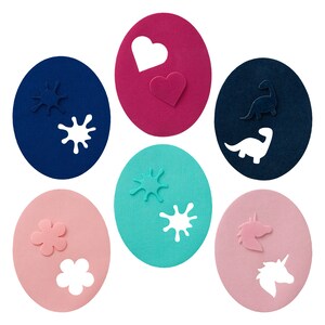 May include: Six colourful circles with different cut-out shapes. The shapes include a heart, a dinosaur, a flower, and paint splatters.
