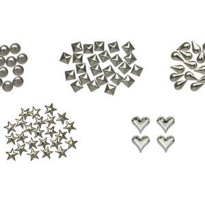May include: A collection of silver metal embellishments, including round beads, pyramid studs, teardrop shapes, star shapes, and heart shapes. These decorative elements are arranged on a white background.