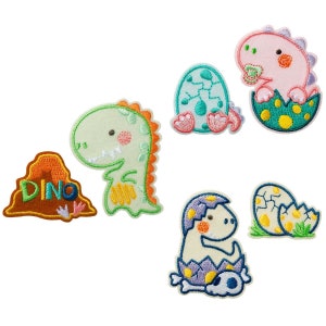 May include: Set of six embroidered iron-on patches featuring cute cartoon dinosaurs in various poses, including a dinosaur hatching from an egg, a dinosaur in a cave, and a dinosaur standing on its own. The patches are colorful and feature a variety of colors, including green, blue, pink, yellow, and brown.