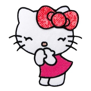 May include: An embroidered patch featuring a white cat character with a large red bow on its head. The cat has black whiskers, closed eyes, a small brown nose, and is wearing a solid pink dress. The design is outlined in black thread.