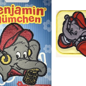 以下が含まれることがあります： 赤い帽子をかぶった灰色の象が、黄色いものを鼻につけています。象は黄色の布のパッチに刺繍されています。パッチには「ベンジャミン・ブリュムヘン」と書いてあります。