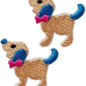 May include: Two embroidered iron-on patches of tan dogs with blue ears and tails and pink bows.