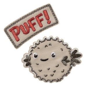 May include: Two embroidered patches on a white background. One is a beige rectangle with the word "PUFF!" in red. The other is a beige, cartoon-style pufferfish with a smiling face and small fins.